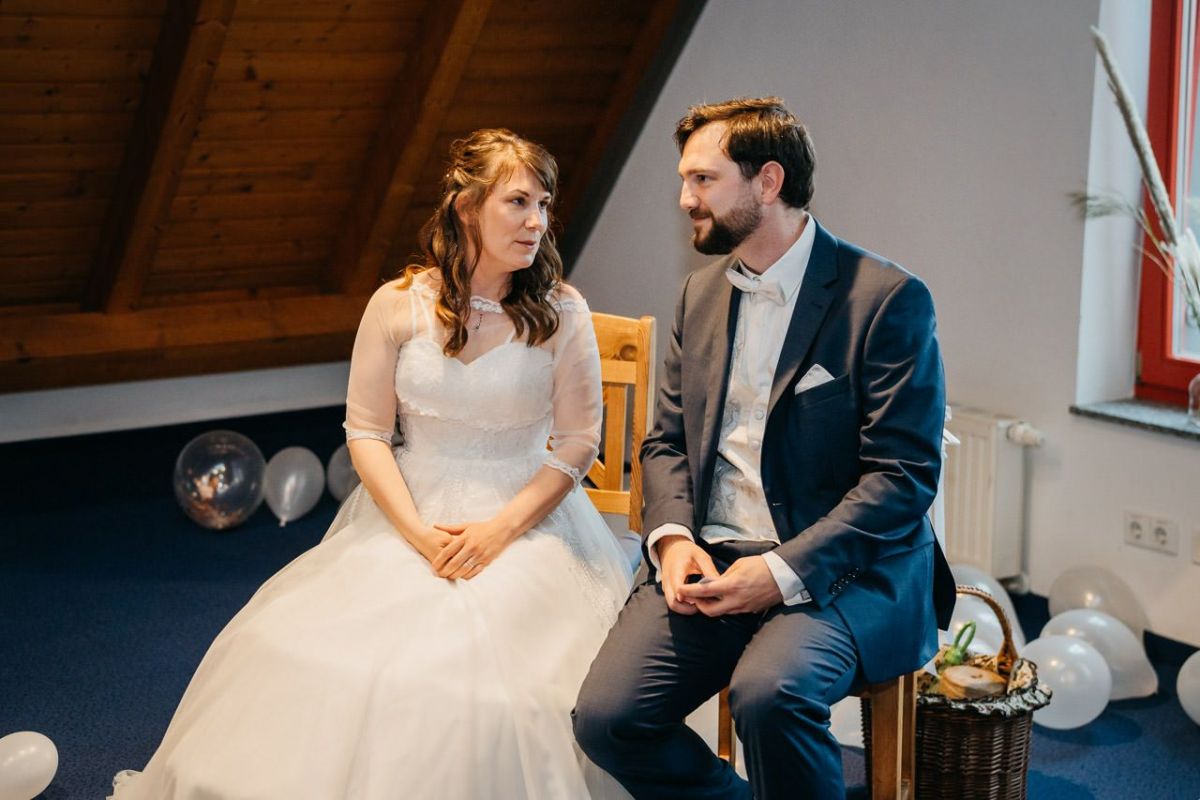 Jana und Thomas sitzen gemeinsam während ihrer Hochzeitsfeier