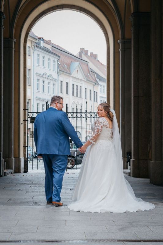 Janina und Tobias laufen lachend durch die Arkaden in Zittau